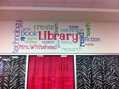 a library sign with zebra print and red curtains