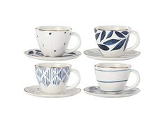 four cups and saucers with designs on them