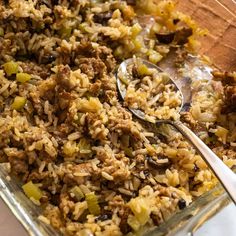 a casserole dish with rice, meat and vegetables