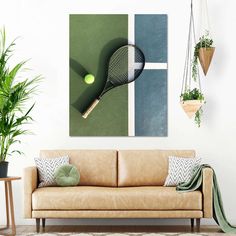 a tennis racket and ball hanging on a wall above a couch in a living room