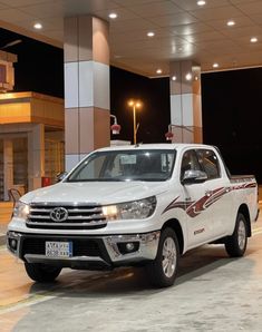 a white truck parked in front of a building