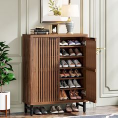 a wooden shoe cabinet with shoes on it