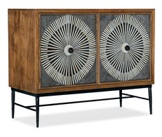 an art deco cabinet with two fans on the doors