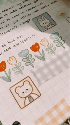 a close up of a book with flowers and animals on it