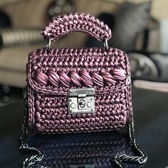 a pink purse sitting on top of a table