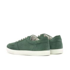 a pair of green sneakers with white soles