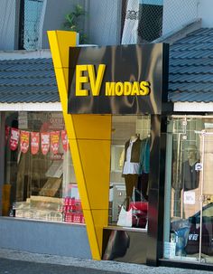 a store front with clothes on display in the window