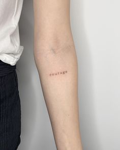 a woman's arm with the word culture tattooed on it