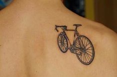 a man with a bicycle tattoo on his back