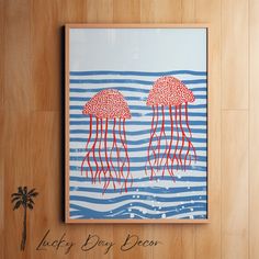 two red jellyfishs floating in the ocean on blue and white striped paper with palm tree