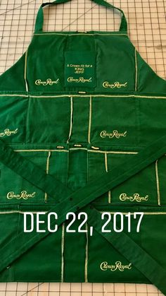 the aprons are green with white writing on them