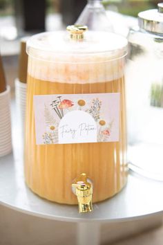 a glass jar filled with liquid sitting on top of a table