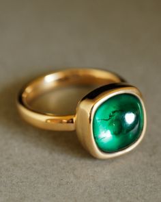 Description A strong, refined statement ring featuring a cushion-cut, responsibly grown Colombian emerald cabochon. No sharp facets or prongs to snag your blazer sleeve, just a delicious gumdrop of bright green held securely by a cup of 18k yellow gold. This is the emerald ring of your dreams. Designed to be worn everywhere and with everything, The Sovereign is just as cool with jeans and a t-shirt as it is with Gucci at the Met Gala. Pairs well with the Essential Band or the Dominus Band (each