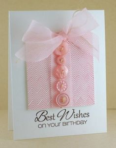 a card with a pink ribbon and a button on it's front that says best wishes on your birthday