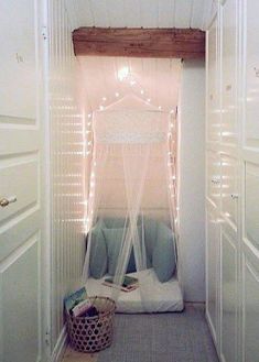 an open door leading to a bedroom with lights on the ceiling and bed in it