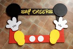 a mickey mouse door hanger with the word say cheers on it's side