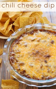 a cheesy dip in a glass dish with tortilla chips on the side