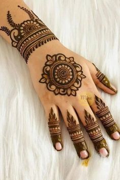 henna tattoo on the palm of someone's hand