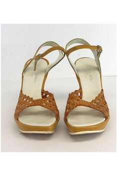 Size 7 Gold Woven Cut Out Leather Wedges Made in France Adjustable ankle straps w/silver-tone buckle In sole wear Some out sole wear Platform height 1" Heel height 4" Insole length 9.5" Fitted Strappy Heels With Round Toe, Fitted Closed Toe Sandals With Buckle Closure, Fitted Leather Sandals With Ankle Strap, Fitted Ankle Strap Sandals With Leather Sole, Fitted Ankle Strap Leather Sandals, Fitted Sandals With Leather Sole And Round Toe, Vintage Sandals With Ankle Strap Medium Width, Vintage Spring Sandals, Fitted Brown Closed Toe Sandals