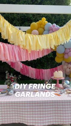 a table topped with lots of balloons and streamers