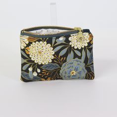 Explore the practicality of our Dawn Garden Coin Pouch, a compact solution for your coins and small items. This coin pouch combines style and functionality, making it a perfect mini wallet or accessory holder. The unique design adds a sophisticated touch to your daily routine. Imagine easily finding your small essentials in this stylish pouch. Order now and keep your belongings neatly organized! Accessory Holder, Accessories Holder, Market Tote, Mini Wallet, Coin Pouch, Zip Pouch, Small Items, Wrist Strap, Daily Routine