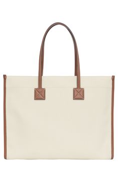 Burberry's Horseferry logo is stamped on the front pocket of this versatile tote that has a casual feel in neutral-hued canvas and topstitched leather trim. Open top Top carry handles Exterior magnetic-flap pocket Interior zip pocket Canvas with leather trim Made in Italy Designer Handbags Canvas Leather Tote, Natural Tan, Top Top, Open Top, Canvas Leather, Leather Trim, Kate Spade Top Handle Bag, Flap Pocket, Leather Trims