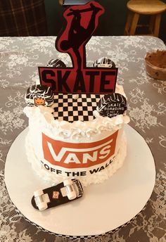 a white cake with black and red designs on it that says skate off the wall