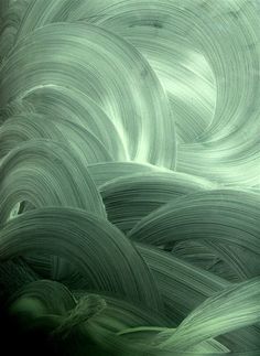 an abstract photograph of green and white swirls