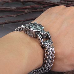 Dive deep into the essence of Norse mythology with this exquisitely crafted bracelet, capturing the spirits of three legendary beings: Fenrir, Berserker, and Hraesvelgr. Fenrir, the formidable wolf, symbolizes raw power and destiny's unyielding force. His story of being bound by gods, yet destined to break free and challenge even Odin, reminds us of the wild and untamed spirit within. The Berserker, representing fierce warriors who fought with unrestrained fury and bravery, invokes courage and passion. Donning bear pelts, these warriors were believed to channel the animal's power and ferocity in battle. Hraesvelgr, the mighty eagle perched at the edge of the world, represents perspective and the vastness of the universe. As the one responsible for the winds that sweep across the lands, Hra Russian Bear, Bear Bracelet, Odin's Ravens, Bracelet Viking, Russian Men, Biker Jewelry, Viking Bracelet, Bear Head, Winter Gear