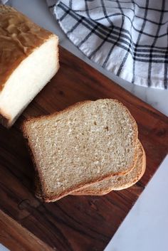 two slices of bread sitting on top of a wooden cutting board