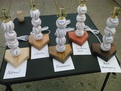 four baseball trophies are sitting on top of a table with cards attached to the bases