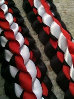 two black, white and red braids laying on the floor