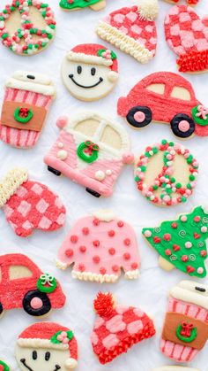 decorated cookies are arranged in the shape of cars and christmas trees on a sheet of white paper