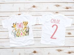 two t - shirts with the numbers 1 and 2 on them, one is for each child