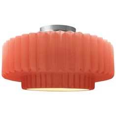 an orange light fixture on a white background