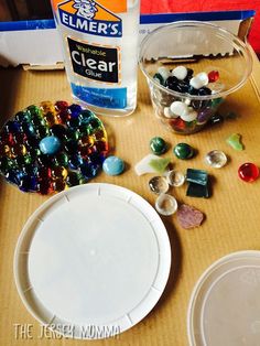 the contents of a craft kit sitting on top of a table next to a bottle of glue