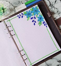 an open notebook with blue flowers on it