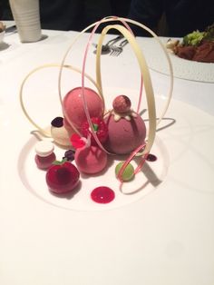 a white plate topped with desserts on top of a table