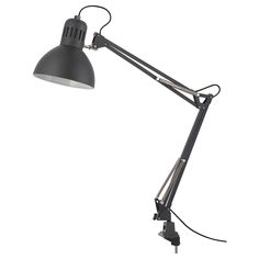 a black desk lamp on a white background with clippings to the light bulb