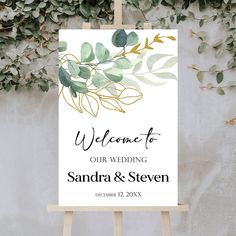 a welcome sign with greenery on it and the words welcome to our wedding, sandra & steven