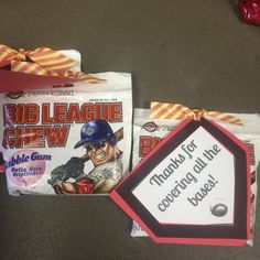 two bags of baseball gum sitting on top of a table next to each other,