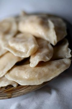 some dumplings are sitting on a wooden plate