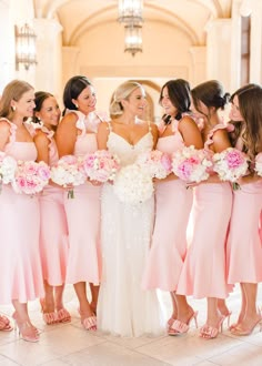 the bride and her bridesmaids are all wearing pink dresses with matching bouquets