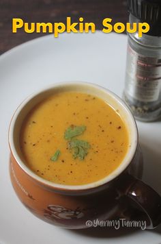 a white plate topped with a bowl of soup next to a jar of seasoning