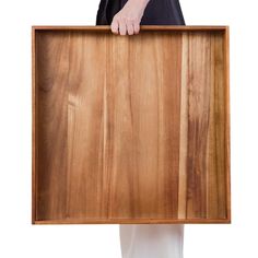 a person holding a wooden board in their hands