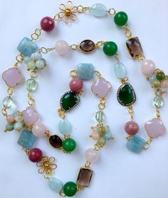 "This spectacular long multi gemstone statement necklace is a whimsical fun fantasy piece handmade and designed by me.  It is made  with 14K gold filled wire and chain, 24K vermeil flower connectors, and links, onto which I carefully wire wrapped the finest quality semi precious gemstones in spring pastel colors, including Flower clusters of Beryl, Rose Quartz faceted rounds, rhodonite faceted rounds,bezel set smokey quartz connectors, 24K gold vermeil connectors in two distinct shapes, square s Crazy Necklaces, Green Statement Necklace, Multi Gemstone Necklace, Freshwater Pearl Drop Earrings, Diy Jewelry Necklace, Handmade Fine Jewelry, Wire Necklace, Quartz Beads, Necklace Long