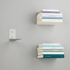 three books are stacked up on the wall