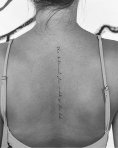 the back of a woman's neck with an inscription on it