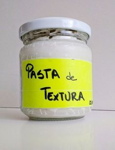 a jar filled with white powder sitting on top of a counter next to a yellow sticker