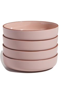 four pink bowls stacked on top of each other